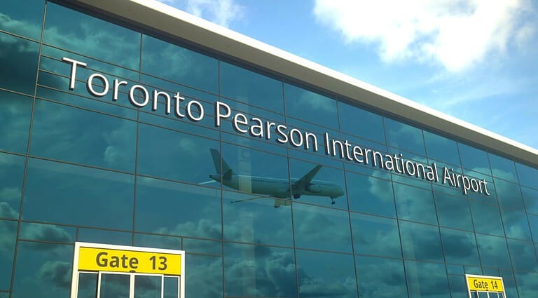 Landing airplane reflects in the modern windoToronto Pearson Internat